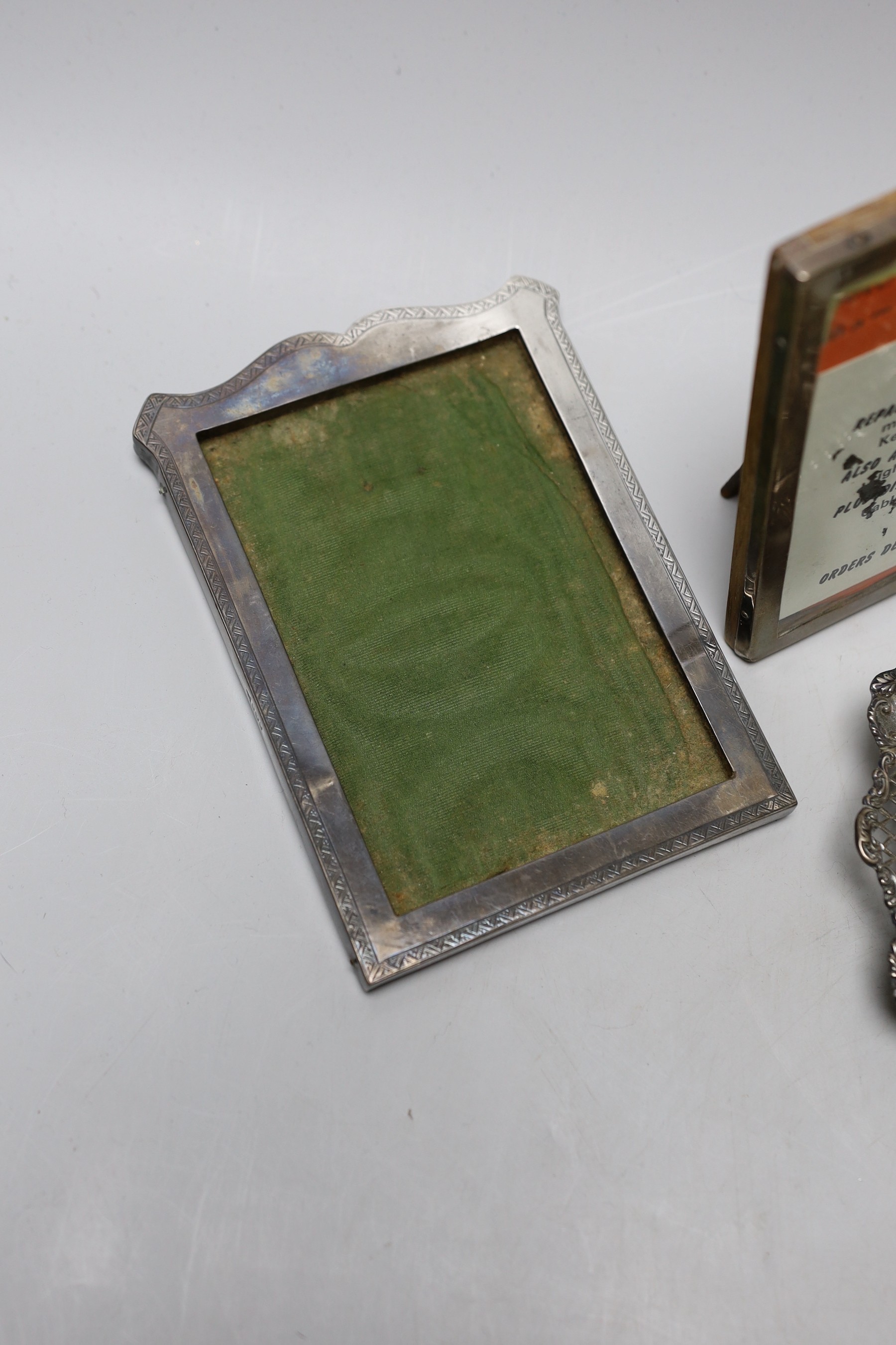 A Victorian engraved silver christening mug, London, 1890, 81mm, a silver napkin ring, a repousse silver dish and three silver mounted photograph frames.